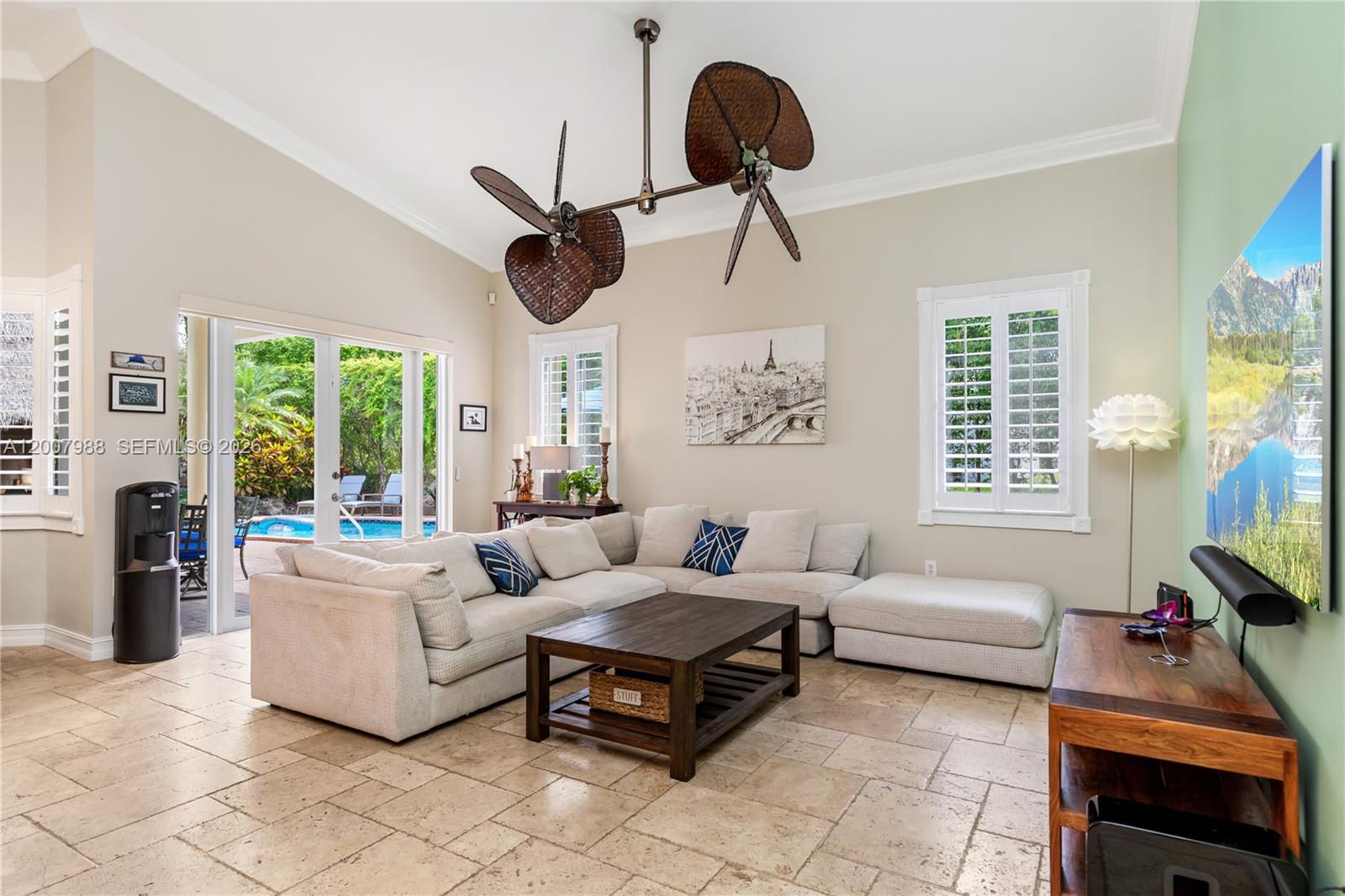 A living room features a sectional sofa, a coffee table, and a unique ceiling fan — 14831 SW 95th Ct, Miami FL 33176, MIAMI, FL