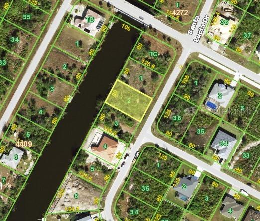 This is an aerial map showing a vacant residential lot highlighted in yellow along a canal — 13391 CHENILLE DRIVE, PORT CHARLOTTE, FL