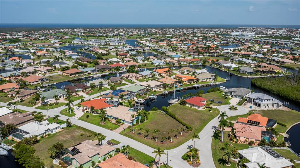 An aerial view shows a residential neighborhood with houses situated along interconnected canals — 1423 GREBE COURT, PUNTA GORDA, FL