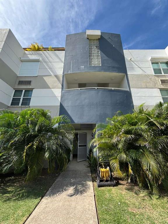 A low-angle exterior view of a multi-story apartment building with a central blue facade — PH 1-A ARROYO BEACH RESORT UNIT PH1-A, ARROYO, PR