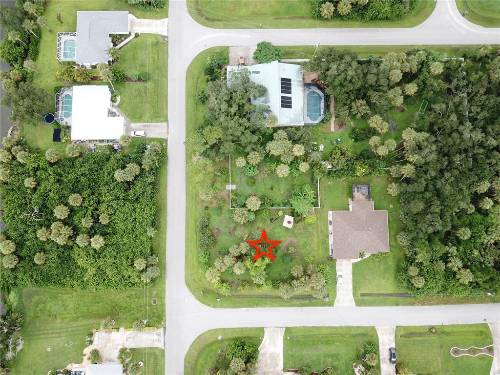 This aerial view shows a residential neighborhood with houses, swimming pools, and landscaped yards — CARIBOU AVENUE, NORTH PORT, FL