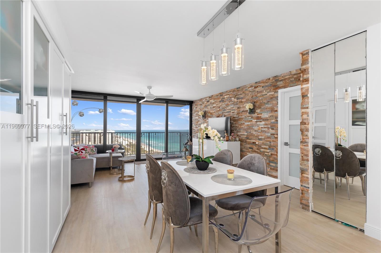 A dining area and living room feature a stone accent wall and ocean views — 2101 S Ocean Dr # 2804, Hollywood FL 33019, HOLLYWOOD, FL