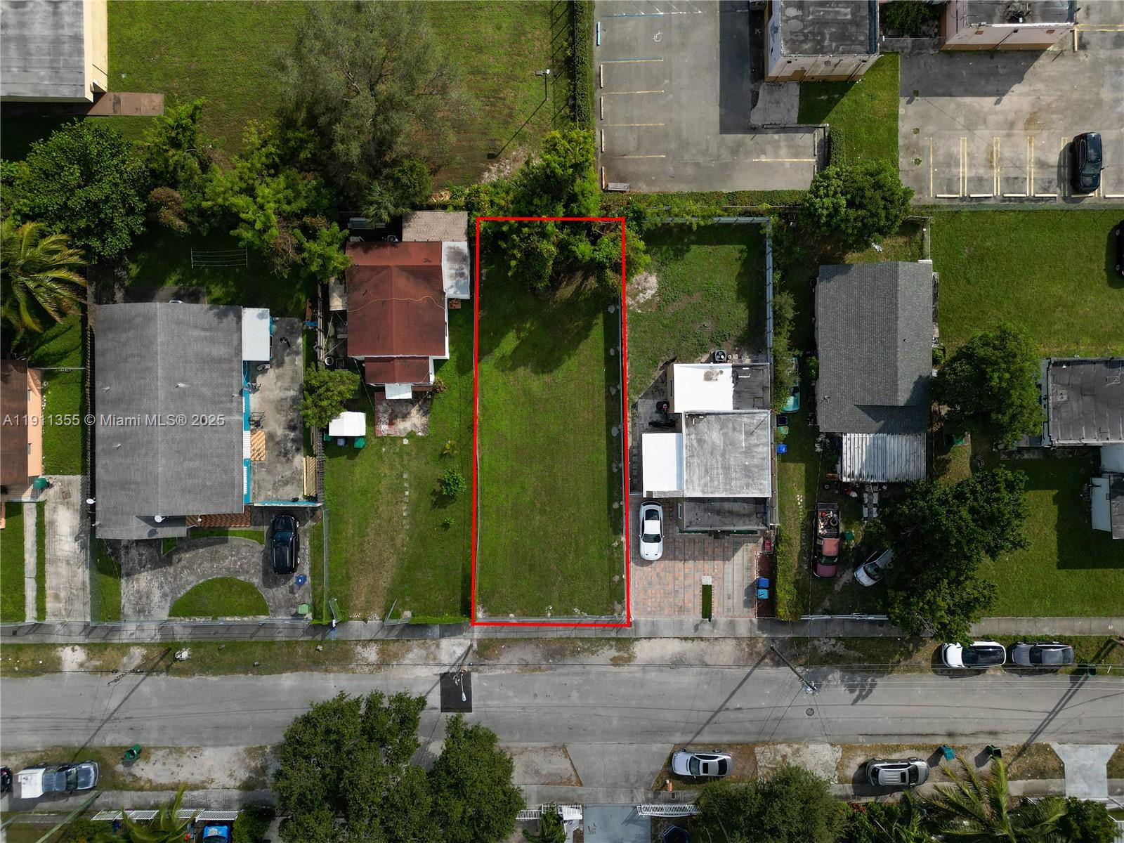 An aerial view shows a vacant rectangular lot outlined in red between two residential properties — 2368 NW 55th St, Miami FL 33142, MIAMI, FL