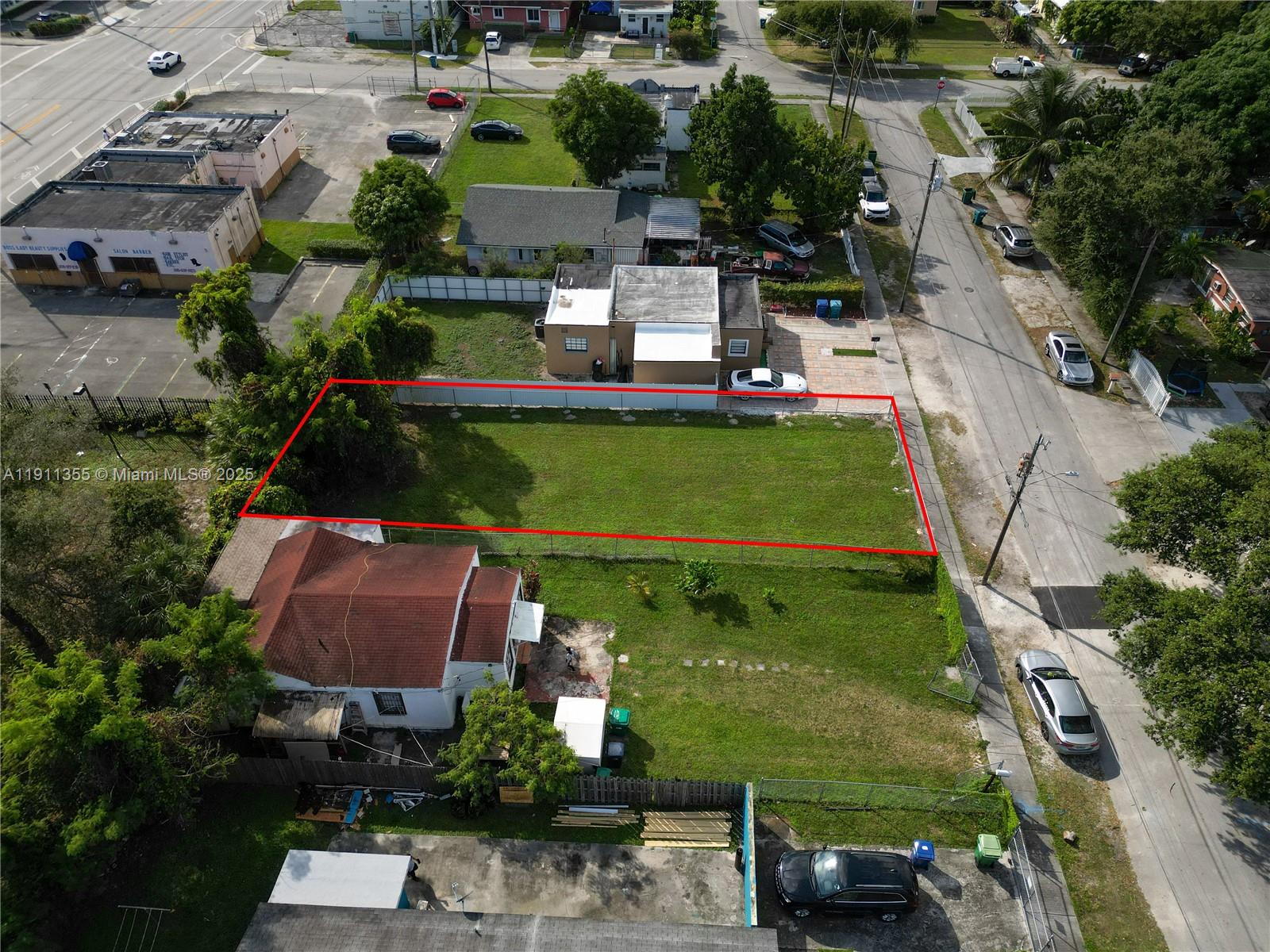 An aerial view shows a vacant rectangular lot enclosed by a chain-link fence — 2368 NW 55th St, Miami FL 33142, MIAMI, FL