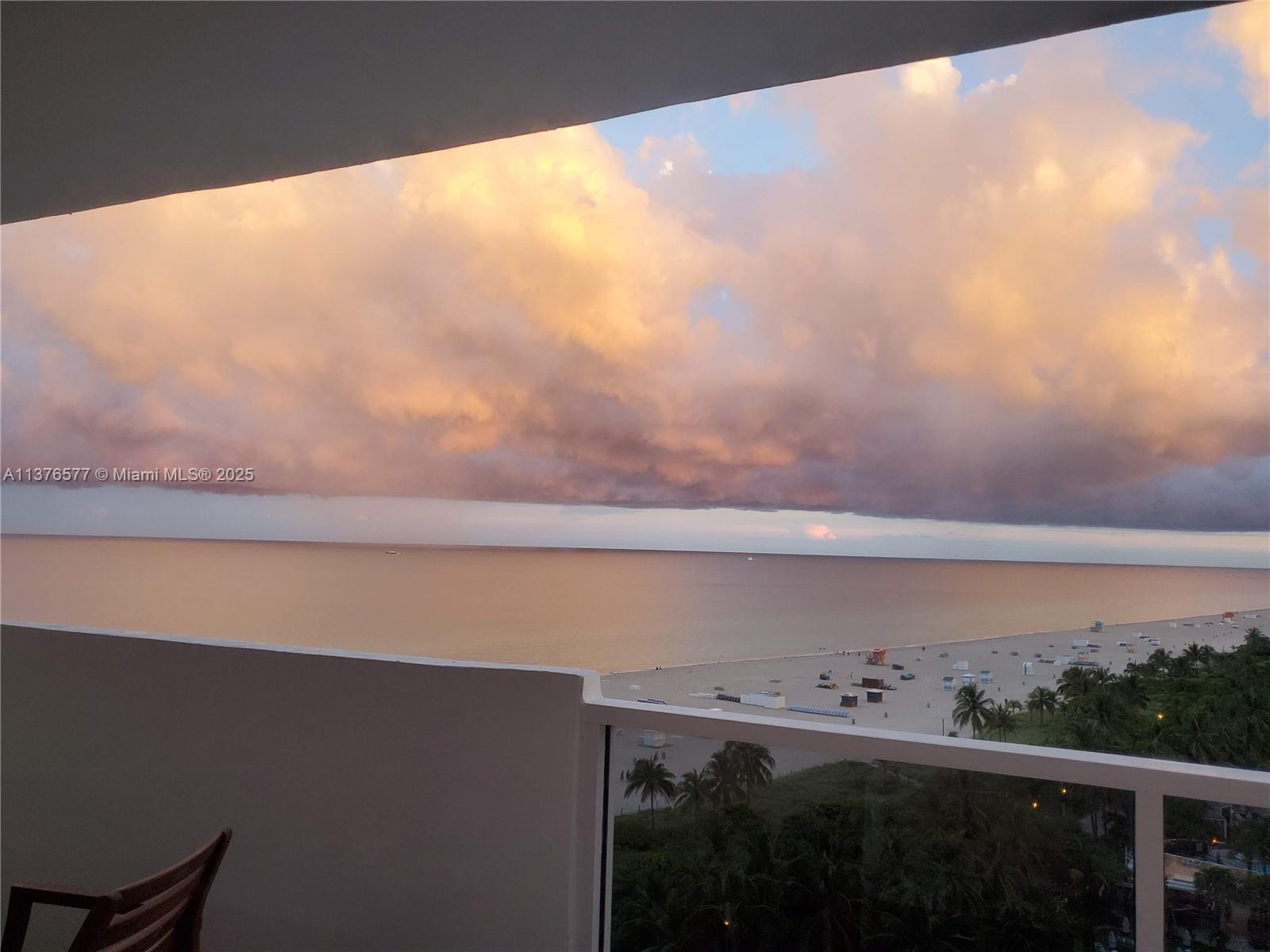 A view of the ocean and beach from a balcony under a cloudy sky — 100 Lincoln Rd # 1244, Miami Beach FL 33139, MIAMI BEACH, FL