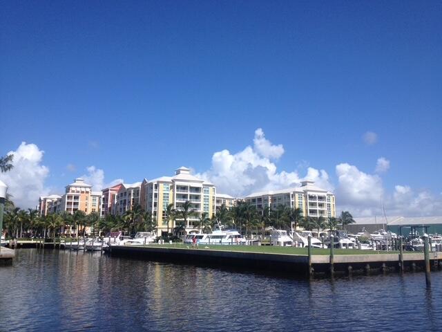 A waterfront view of multi-story apartment buildings with a boat dock in the foreground — 806 E Windward Way # 401, Lantana FL 33462, LANTANA, FL