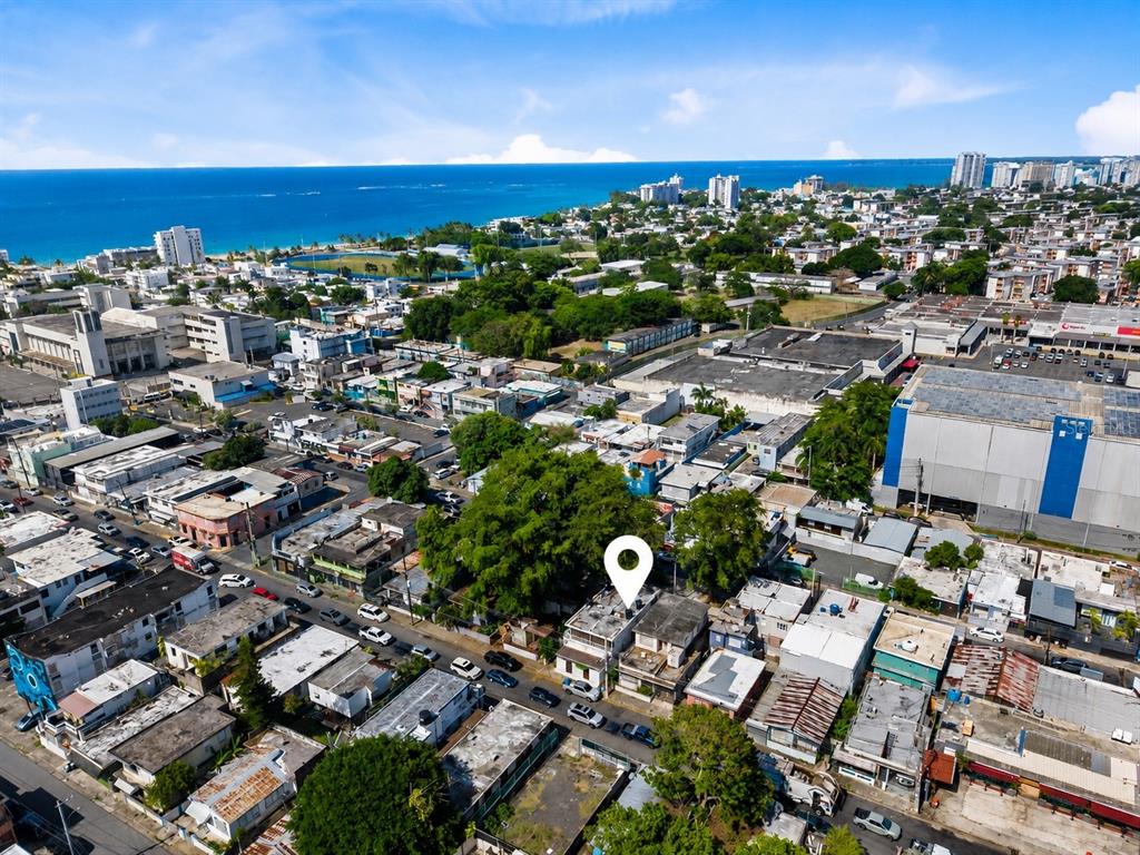 An aerial view shows a city neighborhood near the coast with a location pin marker — 211 CALLE TAPIA, SAN JUAN, PR