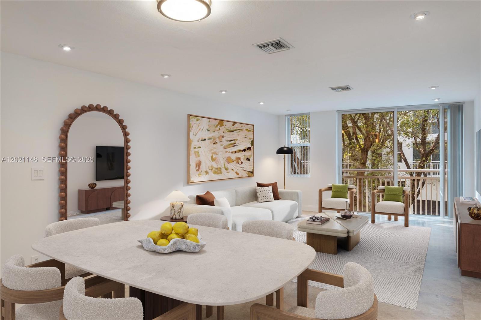 A bright living and dining area features a stone table, white sofa, and arched mirror — 325 Meridian Ave # 5, Miami Beach FL 33139, MIAMI BEACH, FL