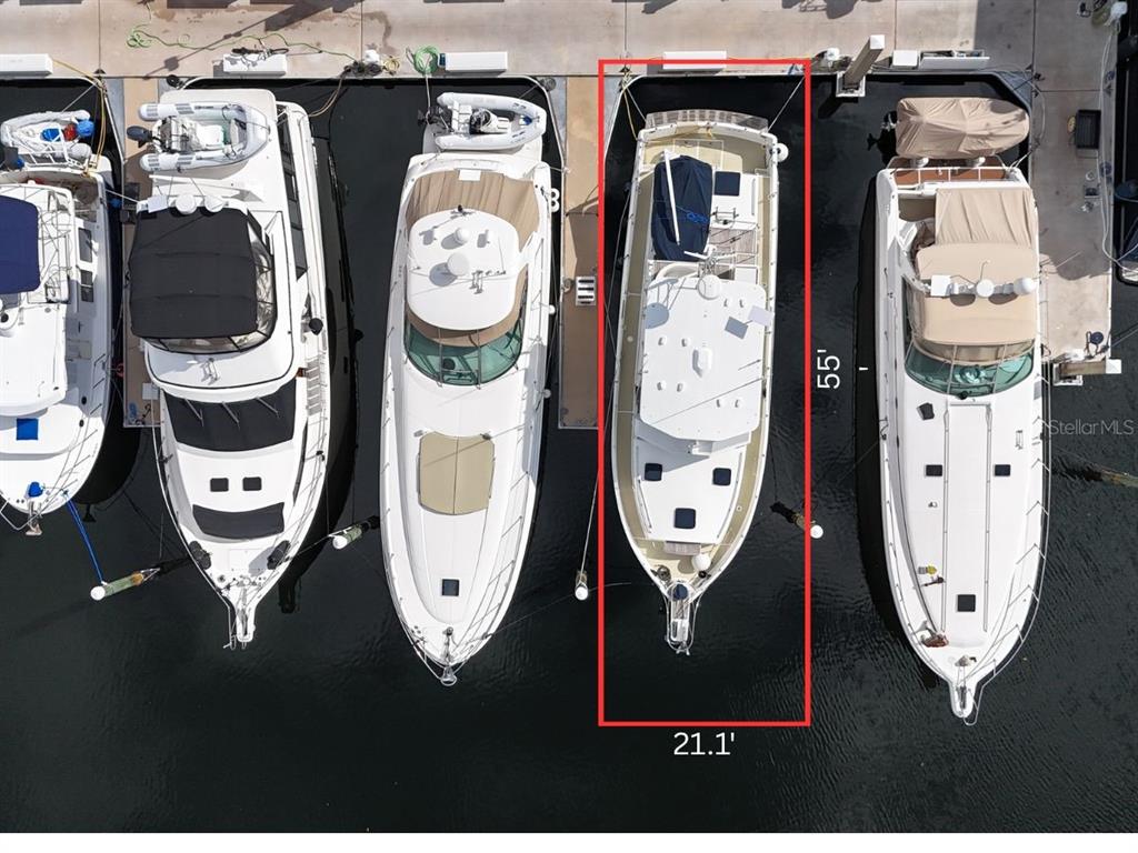An aerial view shows a boat docked in a slip measuring 55 feet by 21.1 feet — 102 RIVIERA DUNES WAY UNIT S-54, PALMETTO, FL