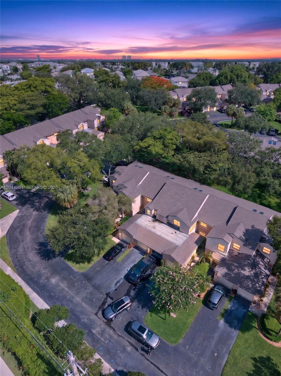 An aerial view shows a multi-unit residential building with dark roofs and surrounding trees — 73 NW 98th Ter, Plantation FL 33324, PLANTATION, FL