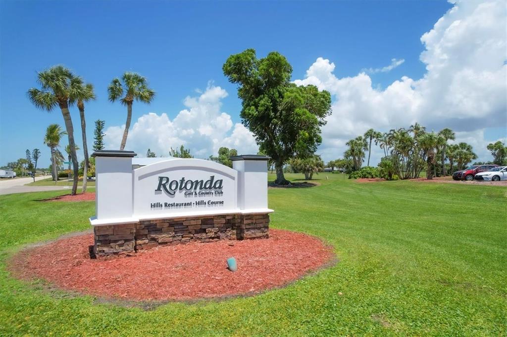 A white monument sign for Rotonda Golf & Country Club sits on a grassy lawn — 144 ROTONDA CIRCLE, ROTONDA WEST, FL