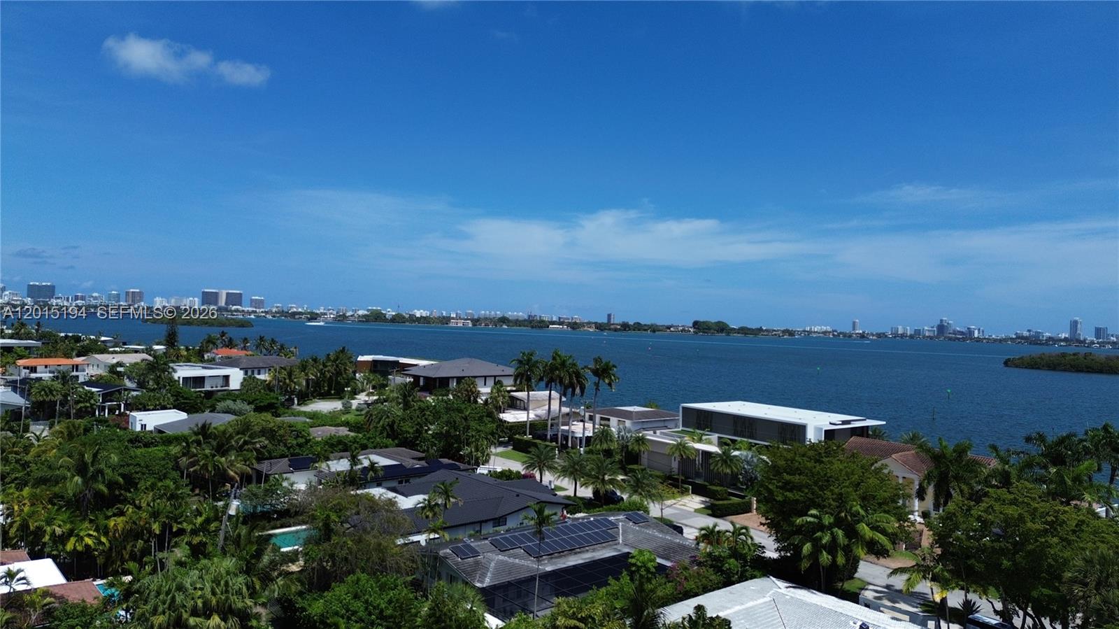 An aerial view shows a house with a red-tiled roof, red doors, and a palm tree — 11445 N Bayshore Dr, North Miami FL 33181, NORTH MIAMI, FL