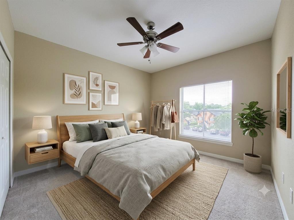 A bedroom features a wooden bed frame, floating nightstands, wall art, and a ceiling fan — 5959 WESTGATE DRIVE UNIT 1535, ORLANDO, FL