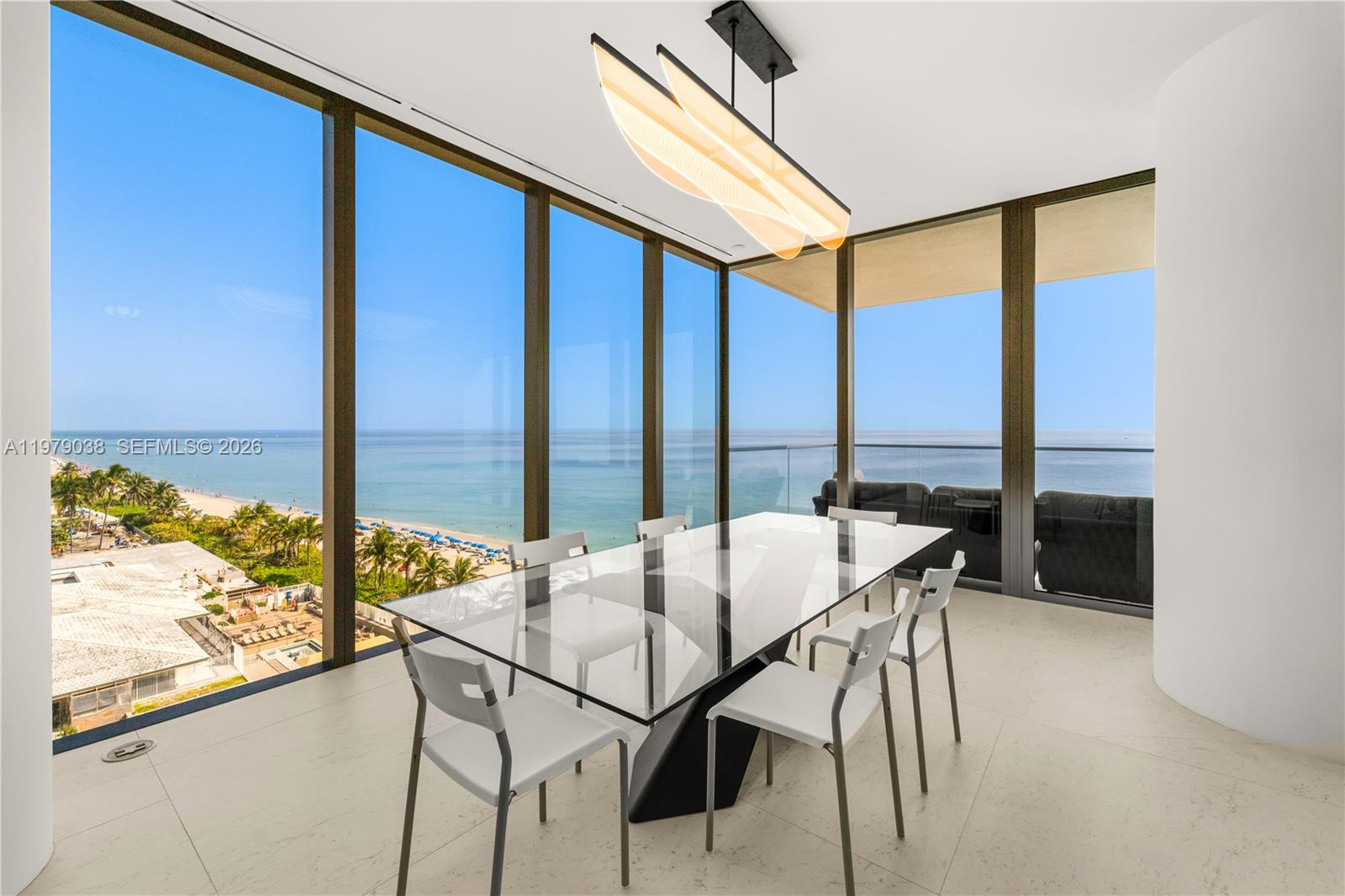 A dining room with a glass table, modern chairs, and floor-to-ceiling windows overlooking the ocean — 2000 S Ocean Dr # 8A, Hallandale Beach FL 33009, HALLANDALE BEACH, FL
