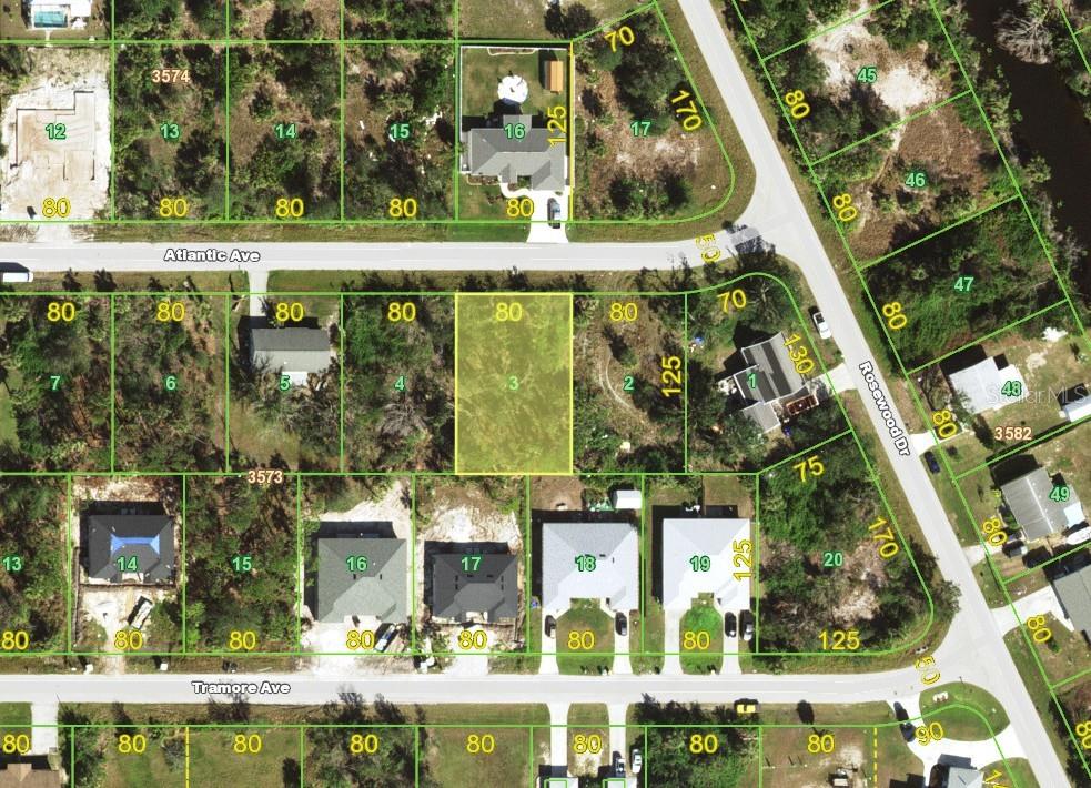 This is an aerial map showing a vacant lot highlighted in yellow among residential properties — 10185 ATLANTIC AVENUE, ENGLEWOOD, FL