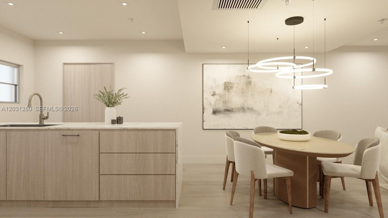 This rendering shows a modern kitchen and dining area with light wood cabinetry and furniture — 250 Collins Ave # 207, Miami Beach FL 33139, MIAMI BEACH, FL