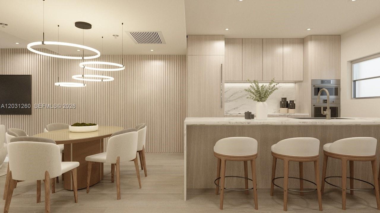 This rendering shows a modern kitchen and dining area with light wood cabinetry and finishes — 250 Collins Ave # 207, Miami Beach FL 33139, MIAMI BEACH, FL