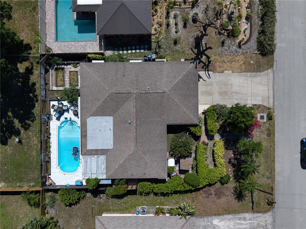 An aerial view shows a house with a swimming pool, driveway, and landscaped yard — 4108 PRESCOTT STREET, SARASOTA, FL
