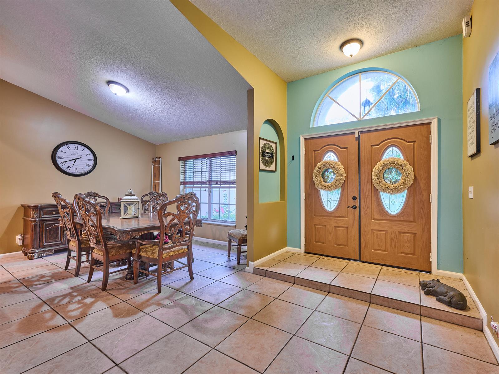 A dining area with a wooden table and chairs sits beside a tiled entryway — 16405 90th Street N, FL 33470, FL