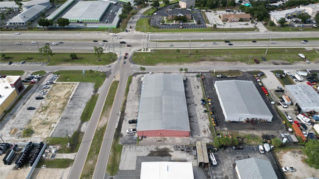 An aerial view shows commercial buildings, parking lots, and a multi-lane highway — 1109 TAMIAMI TRAIL UNIT 5, PORT CHARLOTTE, FL