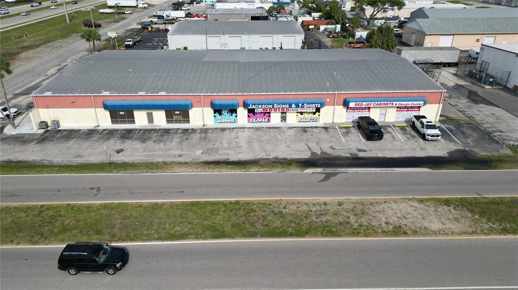 An aerial view shows a commercial building with two businesses and a parking lot — 1109 TAMIAMI TRAIL UNIT 5, PORT CHARLOTTE, FL
