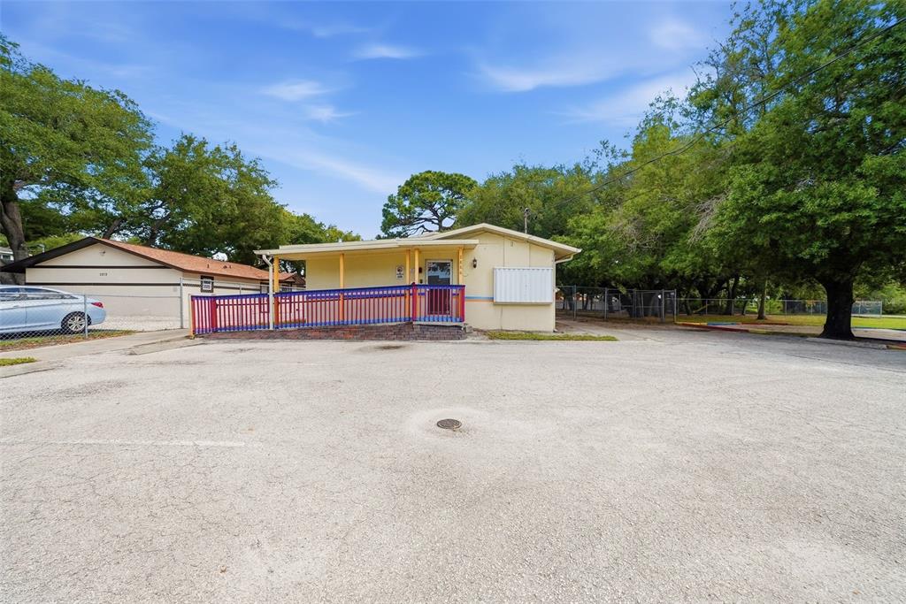 A single-story building with a wheelchair ramp and a large paved parking lot — 2886 WHITNEY ROAD, CLEARWATER, FL