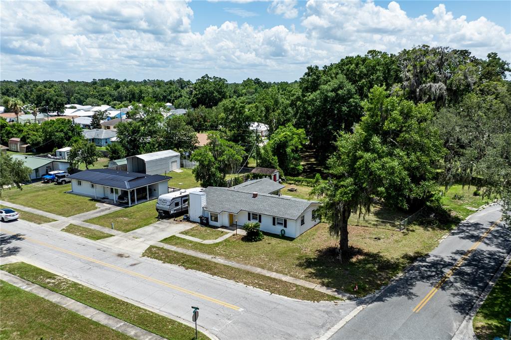 An aerial view shows a single-story house with a detached garage and a parked RV — 294 SE TRIBBLE STREET, LAKE CITY, FL