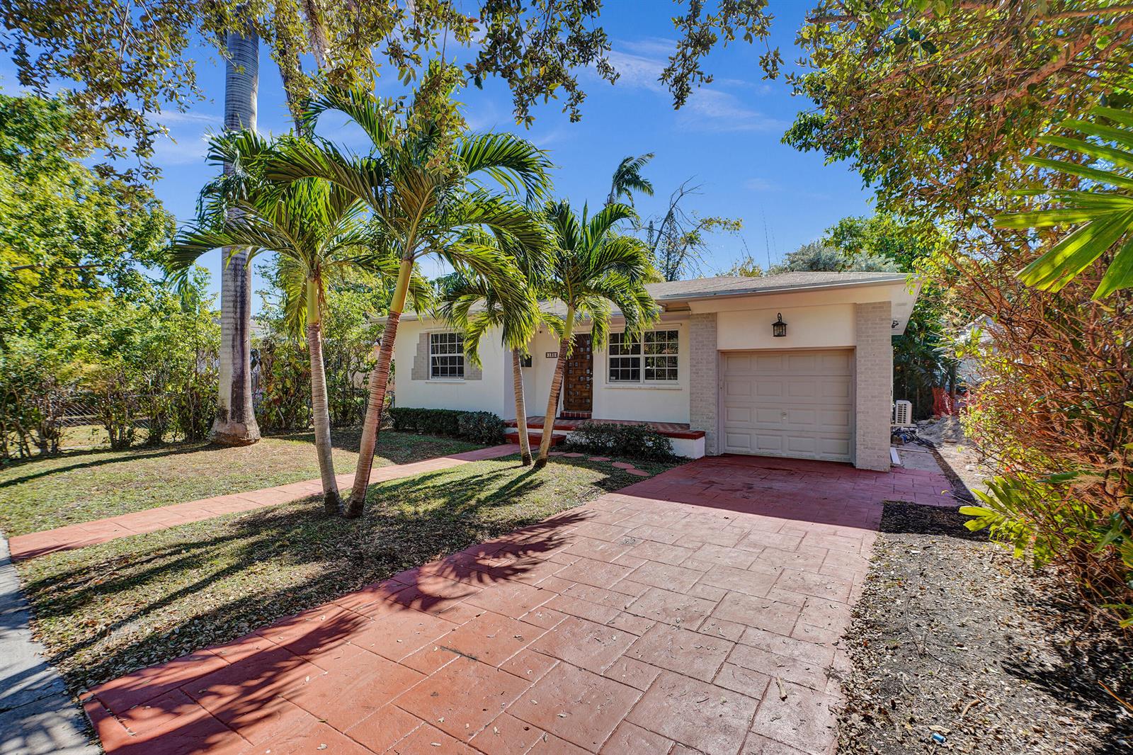 A single-story house with a red paved driveway, palm trees, and a one-car garage — 130 NE 49th Street, Miami FL 33137, MIAMI, FL