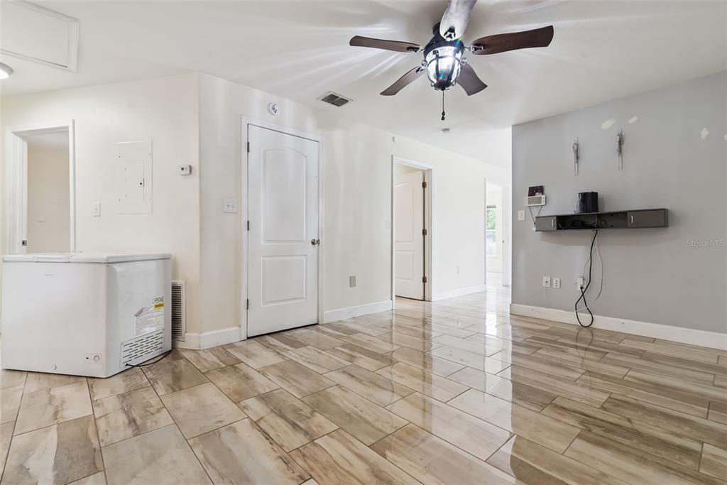 A room with light-colored tile flooring, a ceiling fan, and a white chest freezer — 2260 DOLARWAY STREET, SANFORD, FL