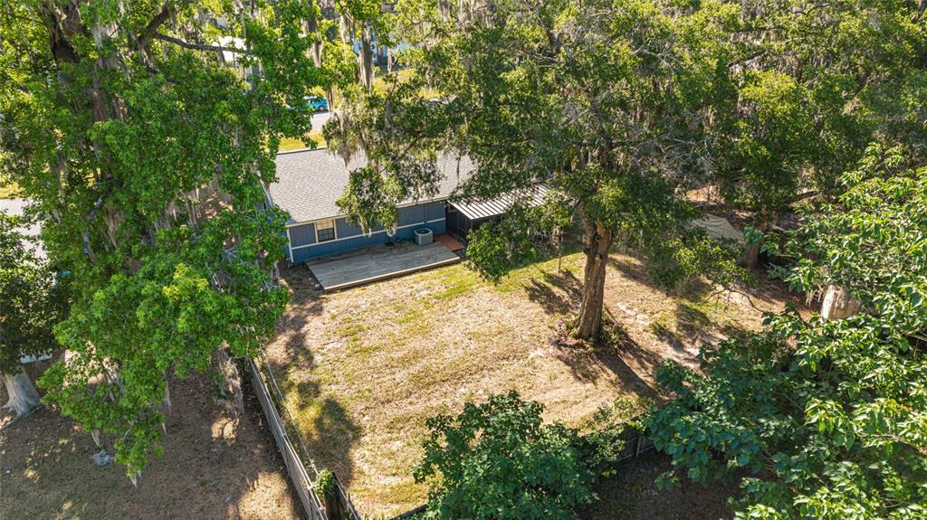 An aerial view of a house with a wooden deck and a large backyard — 5026 SE 33RD TERRACE, OCALA, FL