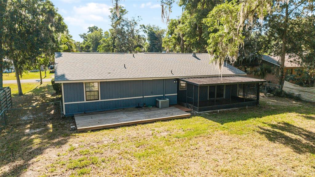 An aerial view of the back of a blue house with a wooden deck — 5026 SE 33RD TERRACE, OCALA, FL
