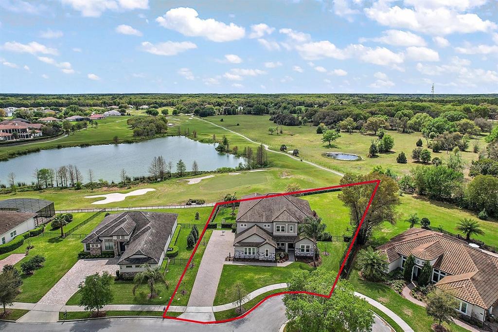 An aerial view shows a two-story house with a red-outlined lot in a suburban neighborhood — 25868 CROSSINGS BLUFF LANE, SORRENTO, FL