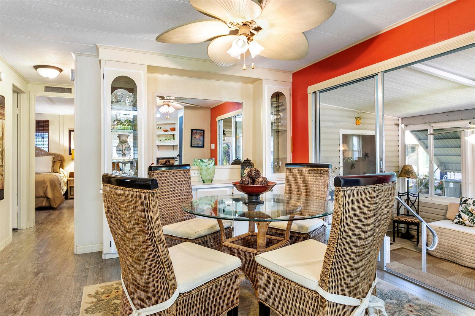 A dining area features a glass-topped wicker table, four wicker chairs, and a ceiling fan — 37039 Exuma Bay, Boynton Beach FL 33436, BOYNTON BEACH, FL