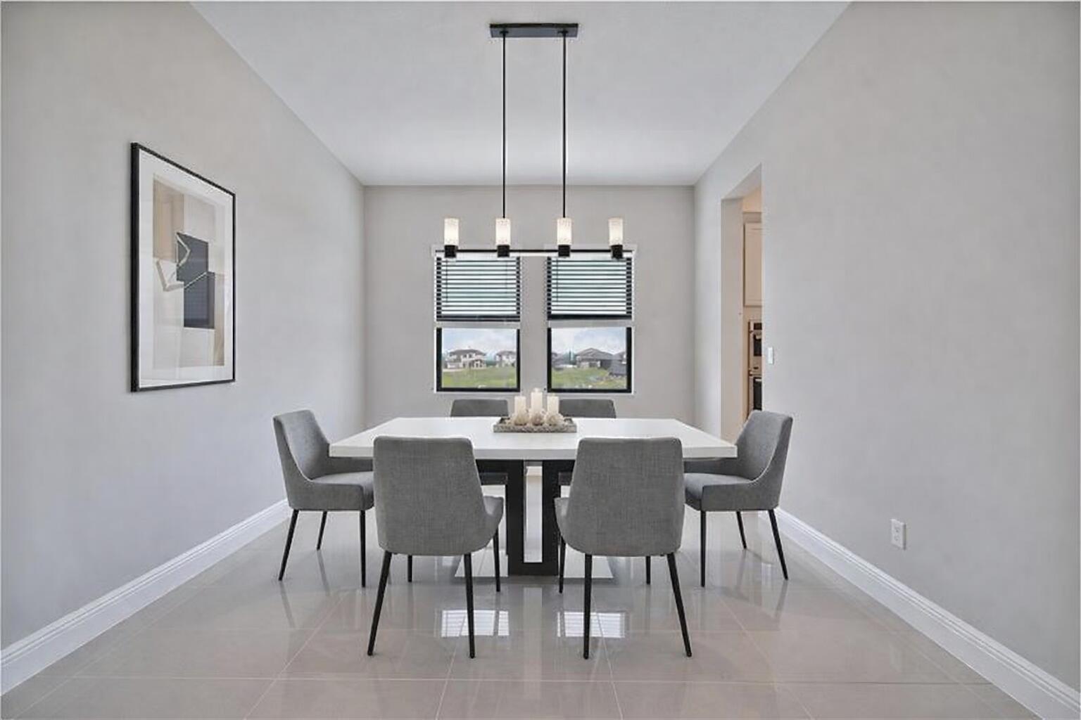A modern dining room features a white table, six gray chairs, and a linear chandelier — 12175 N Baypoint Circle, Parkland FL 33076, PARKLAND, FL