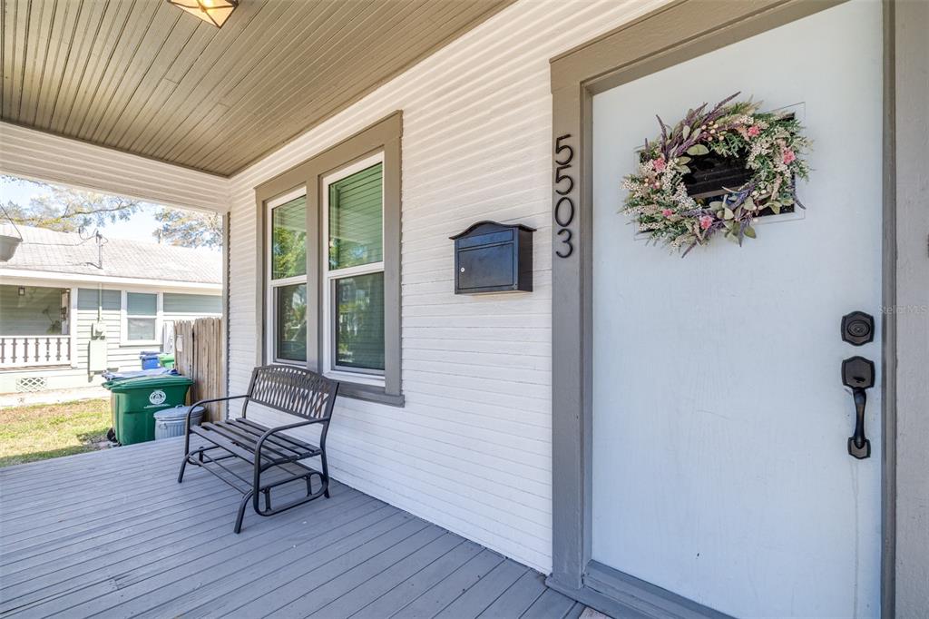 A white front door with a wreath and house numbers sits on a covered porch — 5503 N 9TH STREET, TAMPA, FL