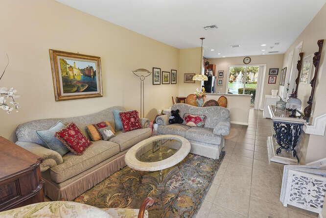 A living room with two sofas, a glass-top coffee table, and tile flooring — 7401 Sarentino Lane # 211, Boynton Beach FL 33437, BOYNTON BEACH, FL