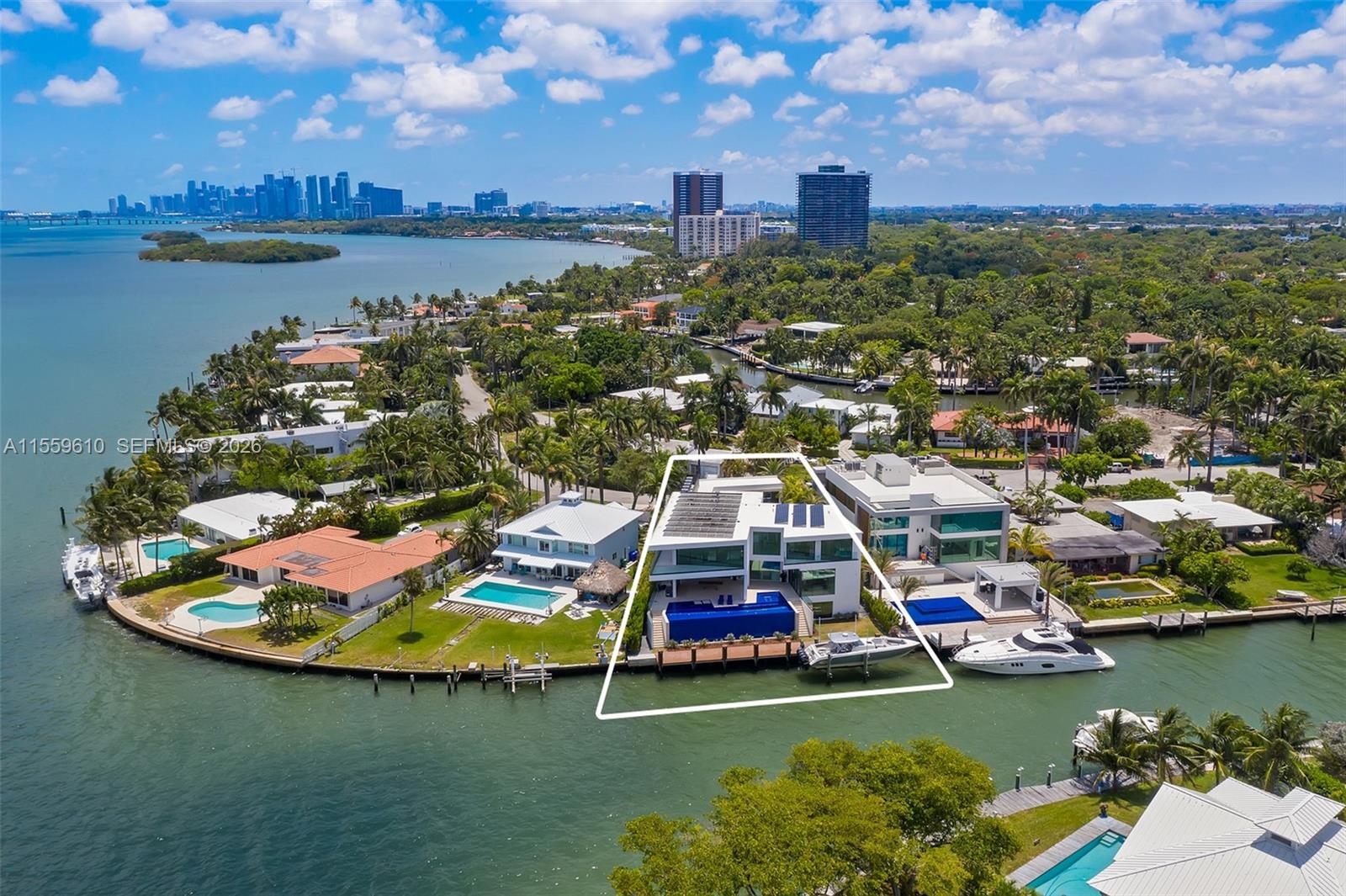 An aerial view shows a modern waterfront house with a pool and boat dock — 1133 Belle Meade Island Dr, Miami FL 33138, MIAMI, FL