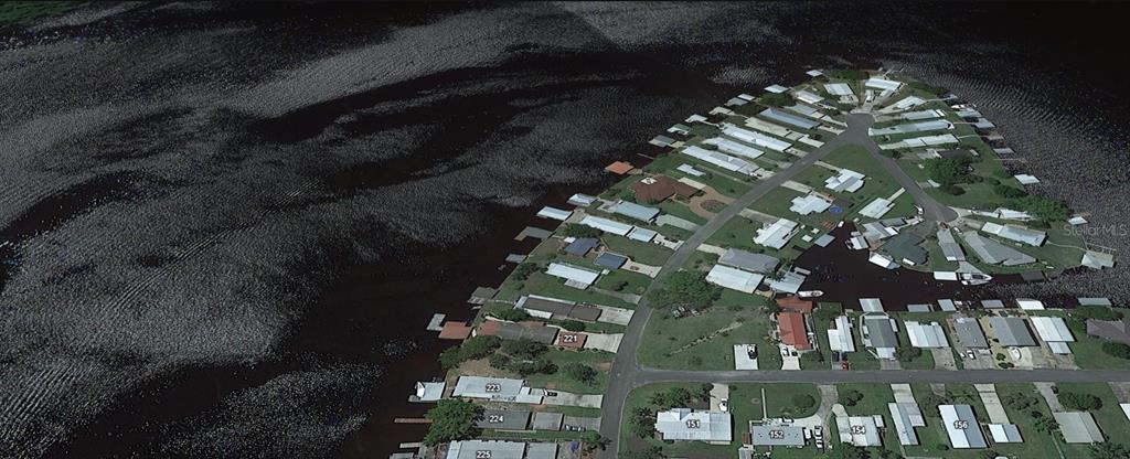 An aerial view shows a residential community of homes situated on a point of land — 179 SPORTSMAN DRIVE, WELAKA, FL