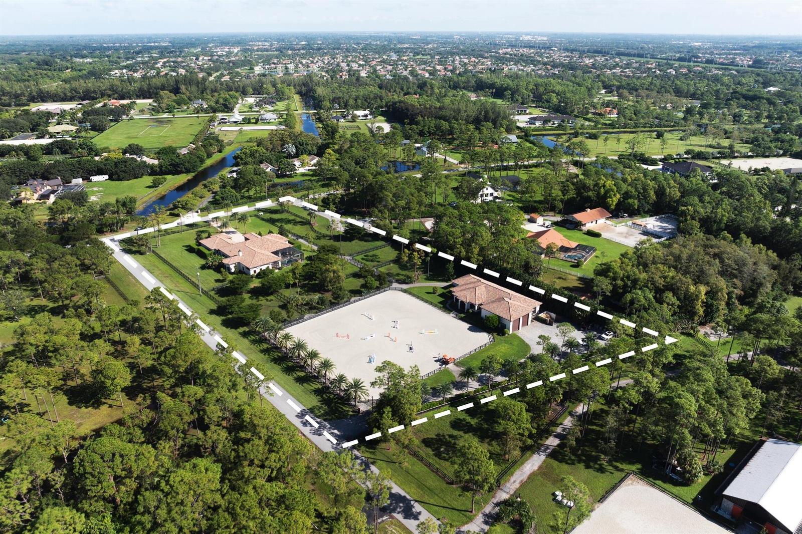 An aerial view shows a residential estate with a large riding arena and two buildings — 11780 Otter Run, Lake Worth FL 33449, LAKE WORTH, FL