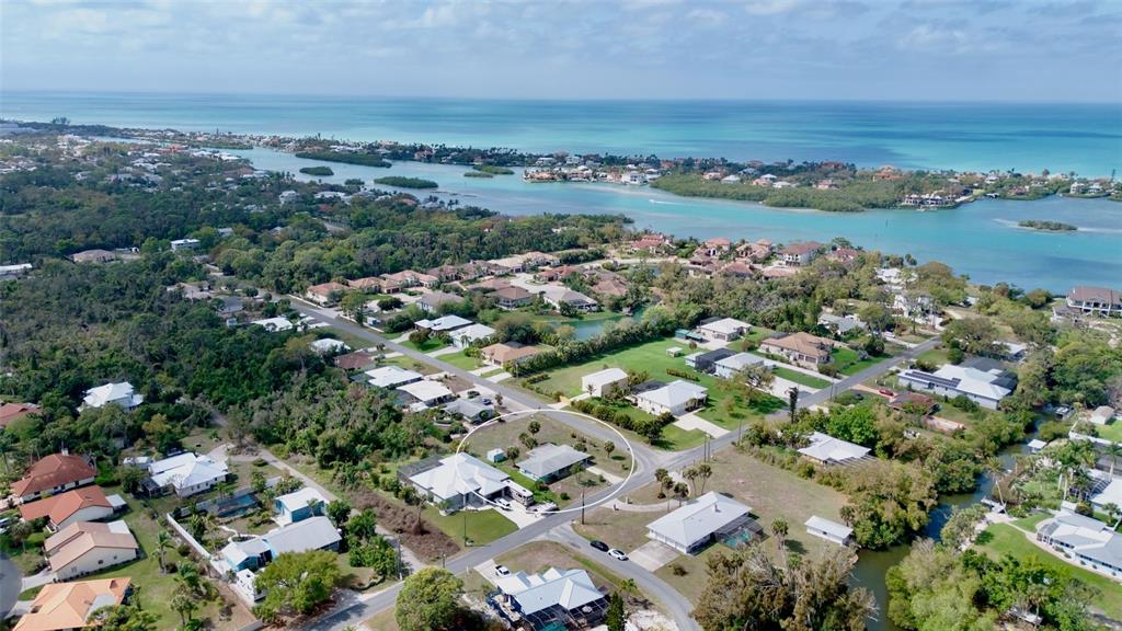 An aerial view shows a residential neighborhood with a circled house near the coast — 223 ROBERTS ROAD, NOKOMIS, FL