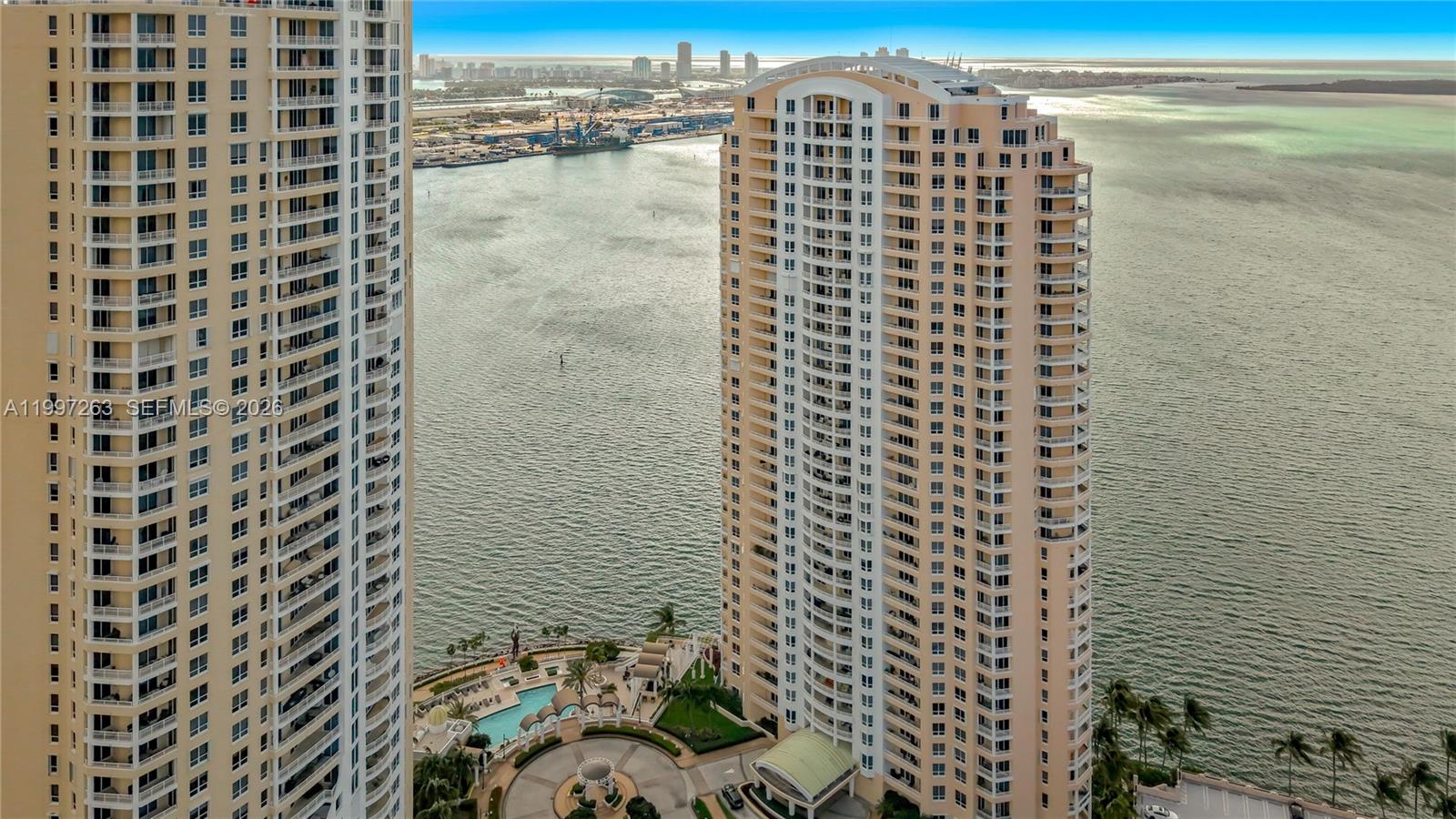 An aerial view shows two tall residential towers situated along a waterfront with a pool — 808 Brickell Key Dr # 2002, Miami FL 33131, MIAMI, FL
