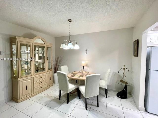 A dining room features a light wood hutch, a round table with four chairs, and tile flooring — 5300 Washington St # S112, Hollywood FL 33021, HOLLYWOOD, FL