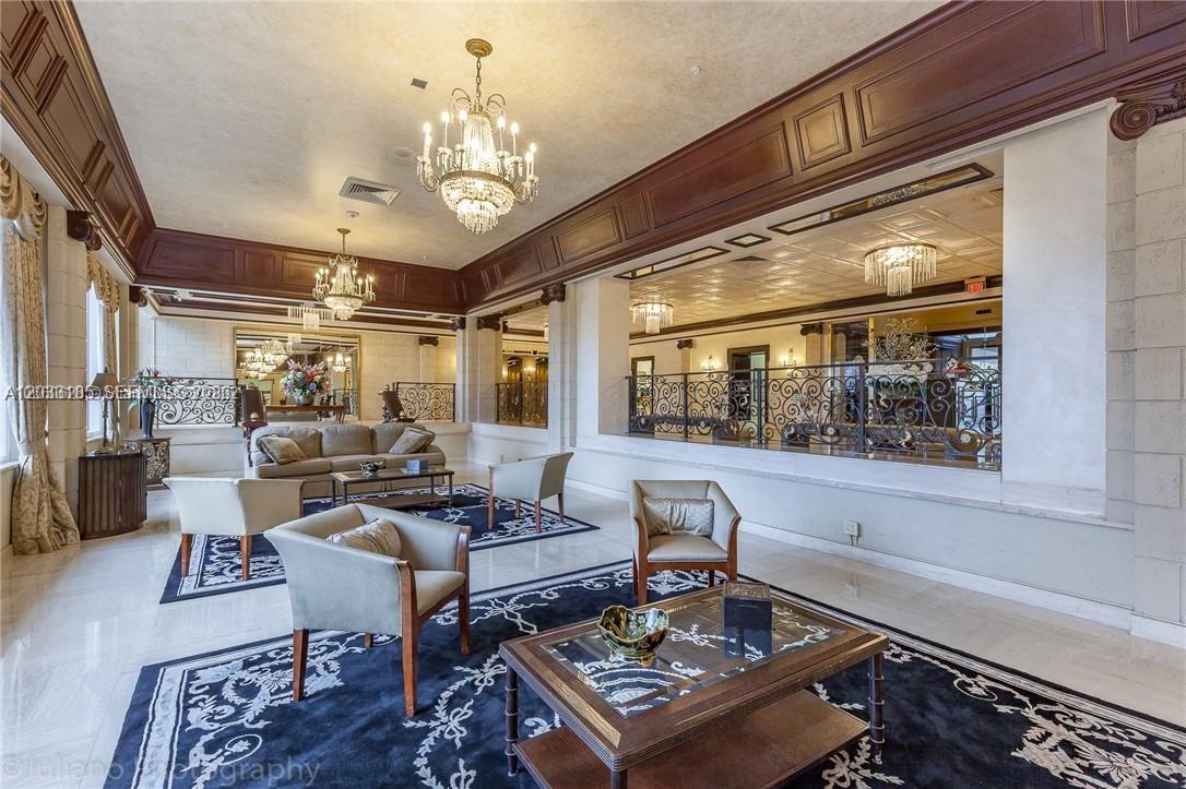A spacious, elegant lobby features dark wood trim, crystal chandeliers, and multiple seating areas — 2030 S Ocean Dr # 1706, Hallandale Beach FL 33009, HALLANDALE BEACH, FL