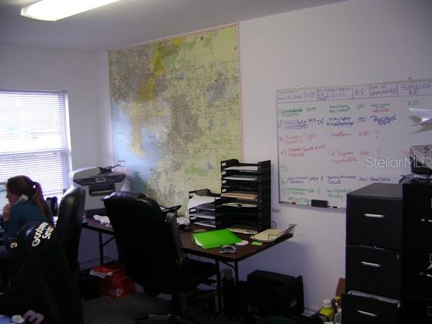 An office space features a large wall map, a whiteboard, a desk, and a filing cabinet — 4101 W CYPRESS STREET UNIT 201, TAMPA, FL