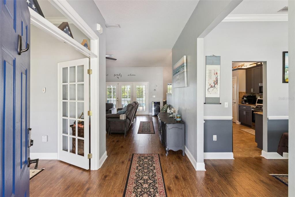 A view from an entryway looking into a living room with wood-look flooring — 2352 MILES COURT, LAKELAND, FL