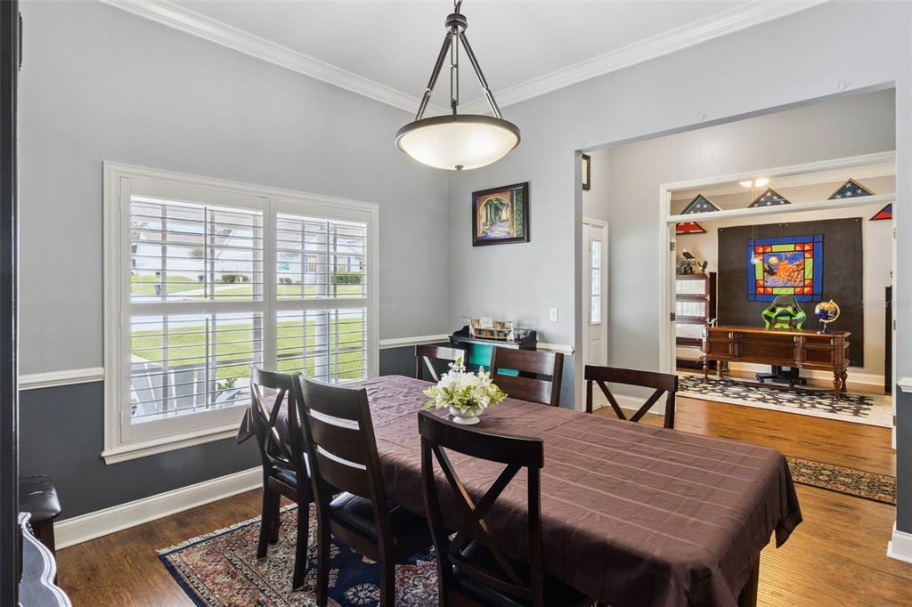 A dining room with a dark wood table, chairs, and a view into an office — 2352 MILES COURT, LAKELAND, FL
