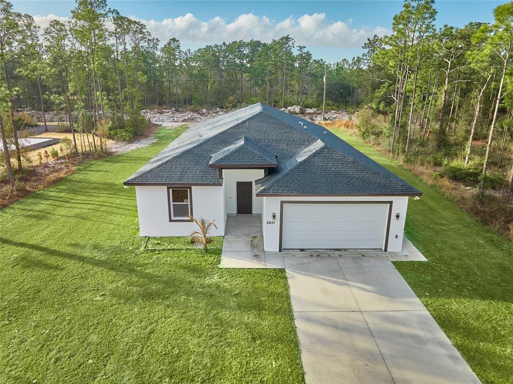 An aerial view of a single-story white house with a dark roof and attached garage — 3431 ORCHID DRIVE, INDIAN LAKE ESTATES, FL