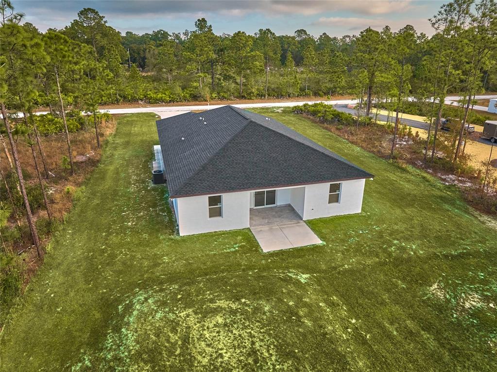An aerial view of a white single-story house with a dark shingled roof and patio — 3431 ORCHID DRIVE, INDIAN LAKE ESTATES, FL