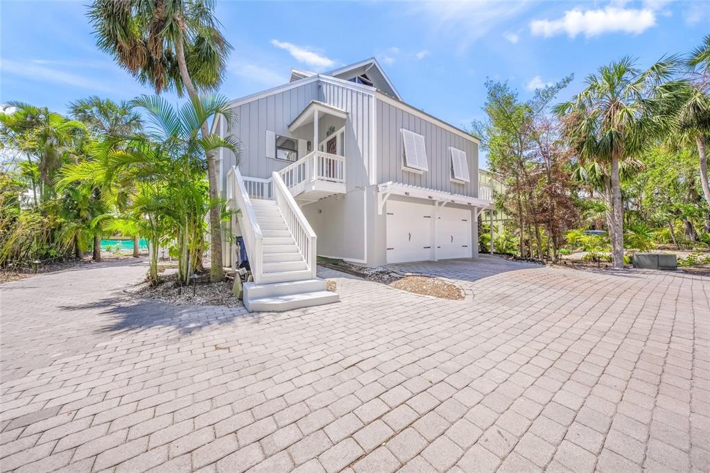 A light gray two-story house with a white staircase and two garage doors — 1256 RIEGELS LANDING DRIVE, SARASOTA, FL