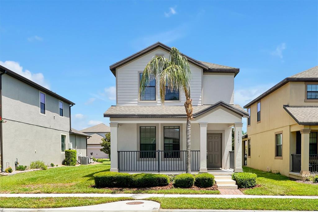 A two-story house with a front porch, a palm tree, and a small lawn — 15101 PURPLE MARTIN STREET, WINTER GARDEN, FL